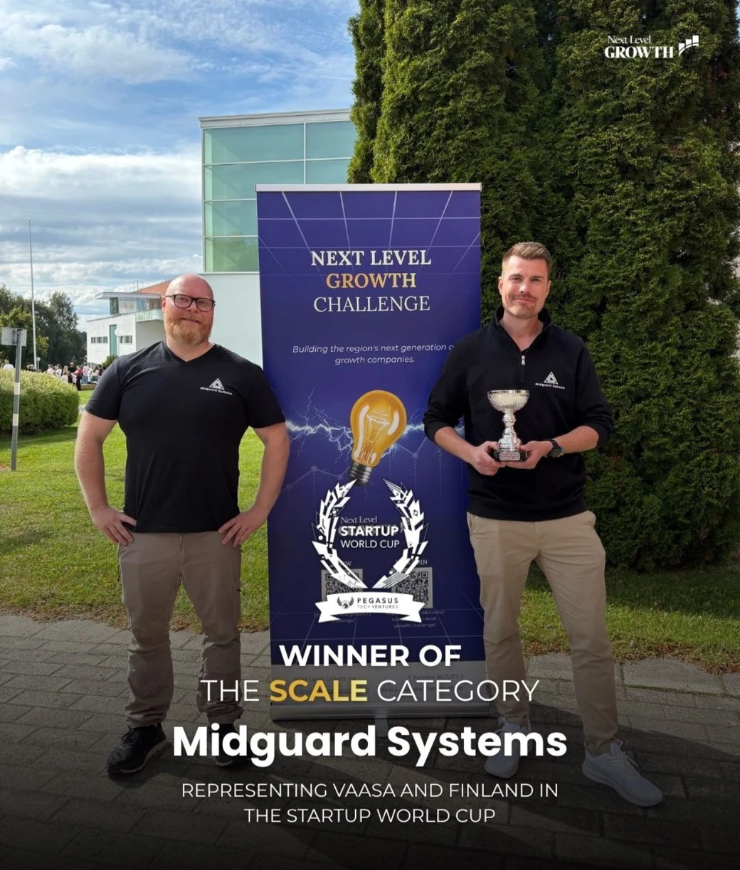 Mikael Holmqvist on the left and Simon Hästö on the right holding the trophy beside a Next Level Growth Challenge banner. Text on the graphic reads: Winner of the Scale category, Midguard Systems, representing Vaasa and Finland in the Startup World Cup.